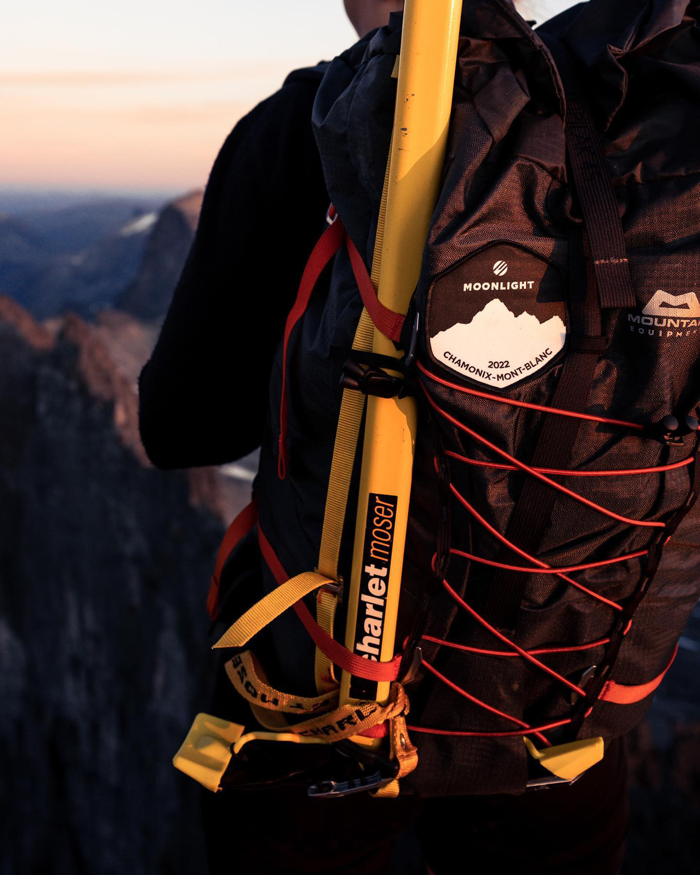 Close up of a backpack from a person looking to mountains.